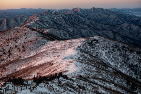 Mountains covered with snow at sunrise. Beautiful winter landscape in the mountains.の写真素材