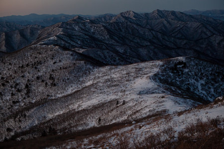 Mountain range in the winter at sunrise. View from the top.の写真素材