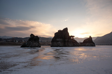 A small island with a pavilion, a frozen river, a morning sunrise sceneの写真素材