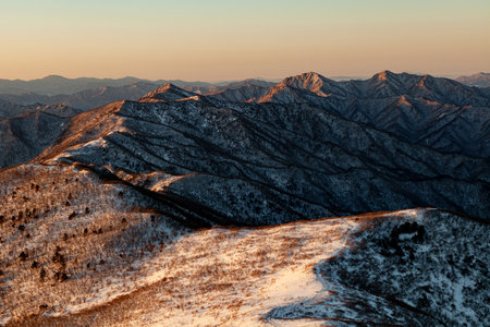 Mountains covered with snow at sunrise. Beautiful winter landscape in the mountains.の写真素材