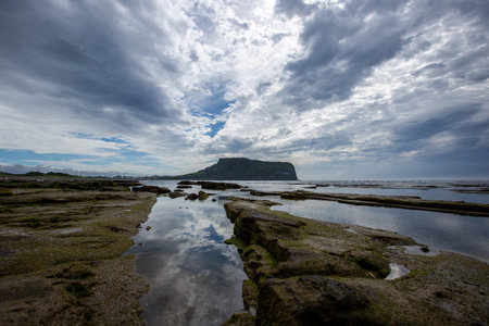 Rocks on the Beach on a Cloudy Day Jeju Sea Sceneryの写真素材