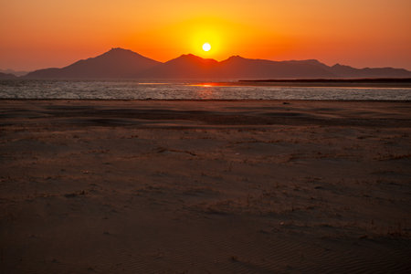 Sunset on the beach with mountains in the background. Scenery. Sand dunes.の写真素材