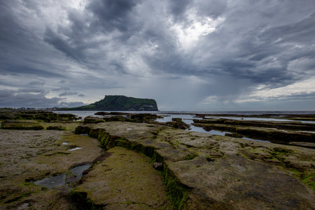 Rocks on the Beach on a Cloudy Day Korea's Jeju Sea Sceneryの写真素材