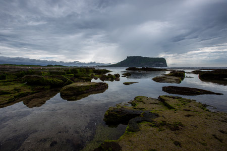 Rocks on the Beach on a Cloudy Day Korea's Jeju Sea Sceneryの写真素材