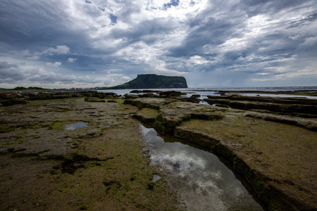 Rocks on the Beach on a Cloudy Day Korea's Jeju Sea Sceneryの写真素材