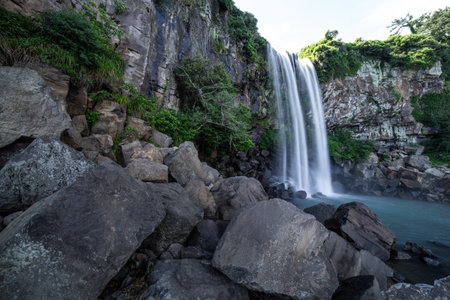 The scenery of Jeju Island in Korea, where the waterfall falls to the cliff is beautifulの写真素材