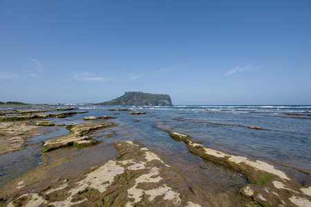 Sunrise Peak scenery towering at the end of the rock, submerged coastの写真素材