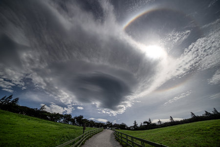 Rainbow in the sky with a path leading to the horizon.の写真素材