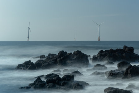 Seascape with wind turbines on the coast of the jeju Sea, long exposure.の写真素材