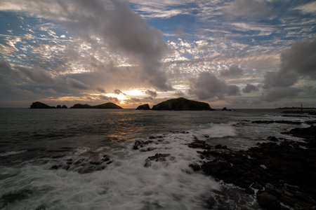 Chagwido sunset view with colorful sky, and waves, Jeju Island, Koreaの写真素材