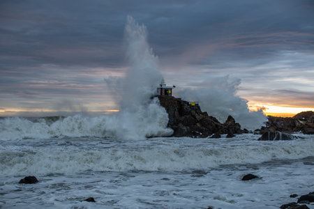 A stormy sea, a scene of huge waves hitting the lighthouseの写真素材