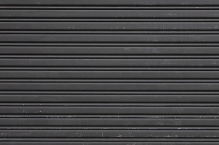 A gray painted shutter door. Texture photoの写真素材