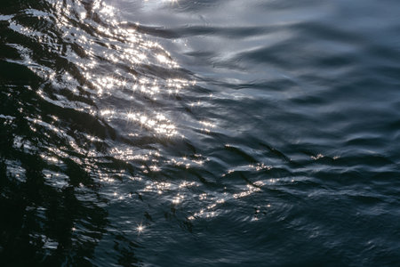 the surface of the water with waves of waves and gleaming waves. Abstract.の写真素材