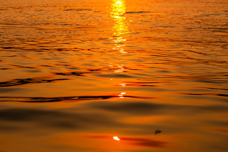 a pattern of waves colored with sunset lightの写真素材