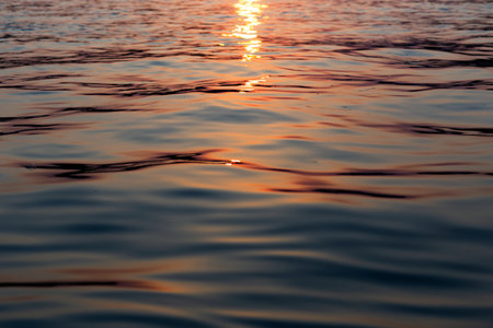 Sunset on the sea. The sun is reflected in the water.の写真素材