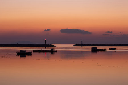 the dawn of a lighthouse and a dusky seaの写真素材