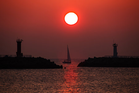 a view of the sea sunrise with a yachtの写真素材