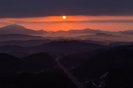 a view of the sunrise from the mountainの写真素材