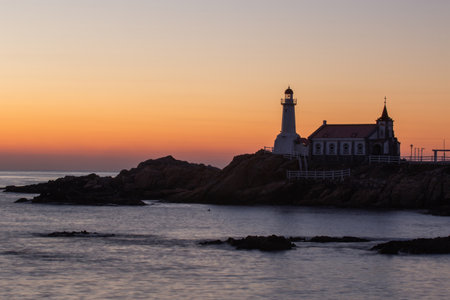 The silhouette of the lighthouse and the morning view of the seaの写真素材