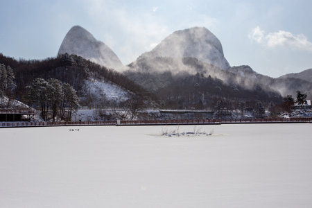 Winter landscape with frozen lake and mountains in the background, South Koreaの写真素材