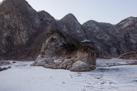 A pavilion on frozen rivers and rocks, Korea.の写真素材