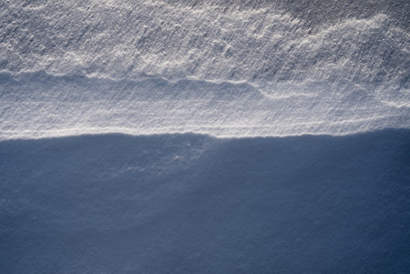 Patterns and textures created by snow and wind. Light and shadow.の写真素材