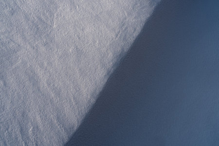 Patterns and textures created by snow and wind. Light and shadow.の写真素材