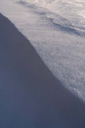 Patterns and textures created by snow and wind. Light and shadow.の写真素材