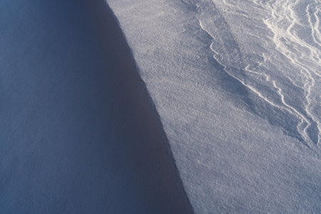 Patterns and textures created by snow and wind. Light and shadow.の写真素材