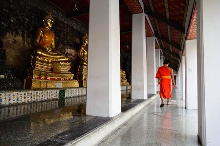 A monk walk in a temple(Wat) in peaceful moment ,Bangkok,Thailand.のeditorial素材