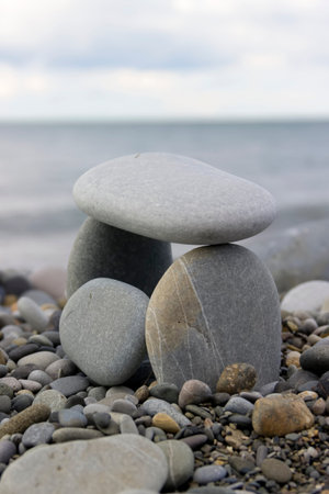 House built rocks on sea shore closeup balance stones upon each other pyramid
