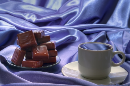 a cup of hot  black coffee with caramel cubeの写真素材