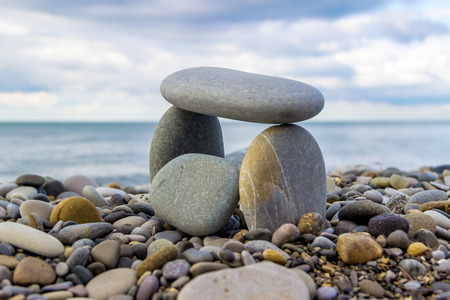 House of sea stones built by the sea on the backdrop of a cloudy sky closeupの写真素材