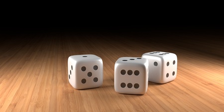 Three dice on wood with black in the backgroundの写真素材