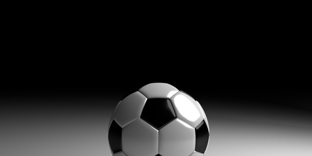 Soccer ball on white surface with black fading in the backgroundの写真素材