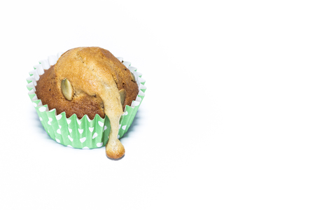Closeup over the mold paper of homemade banana muffin on white backgroundの写真素材