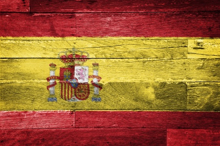 spain flag painted on old wood backgroundの写真素材