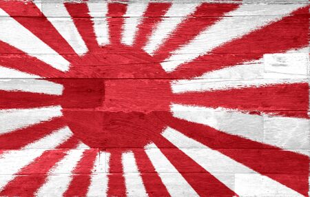 The military flag of Japan painted on old used wood backgroundの写真素材
