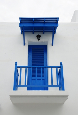 Blue door on white wall with verandaの写真素材