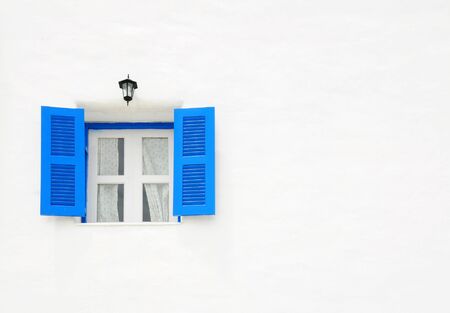 Blue window on the white wall with empty spaceの写真素材