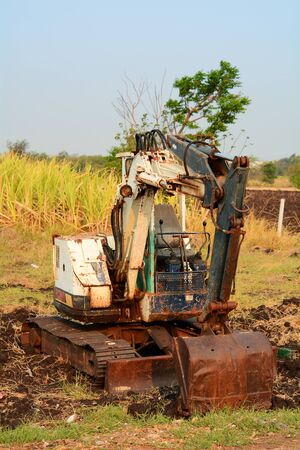 Old excavator on blue sky backgroundの写真素材