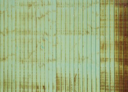 Old green rusty and dirty galvanized fence sheet backgroundの写真素材