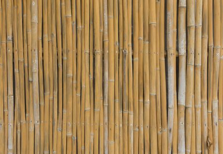 Old brown bamboo plank fence texture for backgroundの写真素材