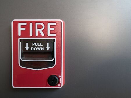 red fire alarm on gray background