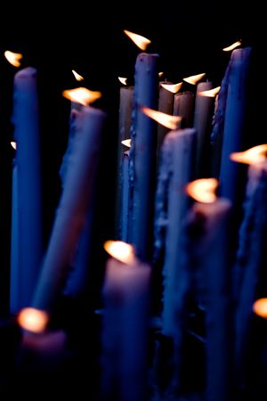 Candles blue tint applied, burning in the altar of the church.の写真素材