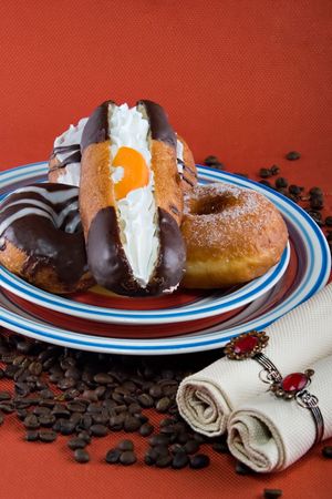 assorted chocolate cream donuts and coffee beans, design element series