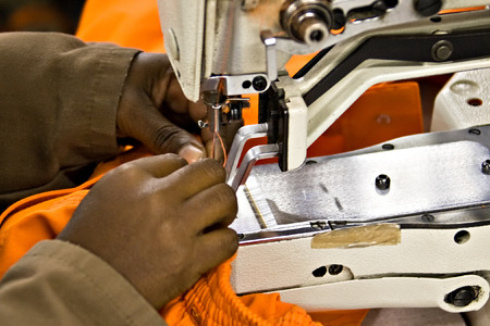 African American woman working at the bartack machine, industrial series
