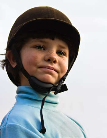 Portrait of small girl with a protective riding hat early in the morningの写真素材