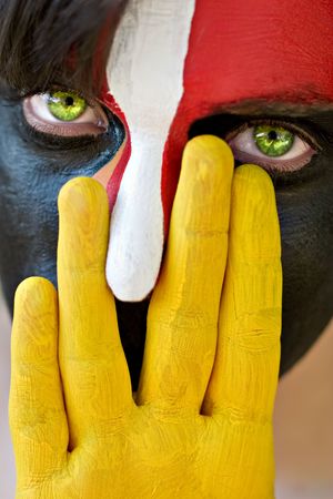 Young man with colorful painted face, conceptualの写真素材