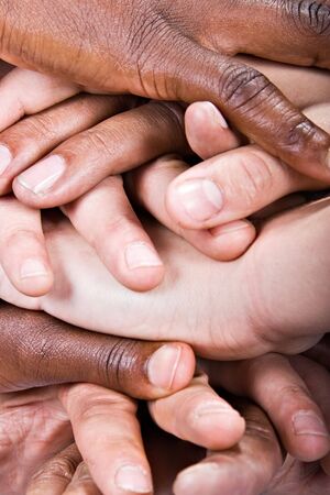 Background pile of hands, Caucasian, African American, Hispanic race.